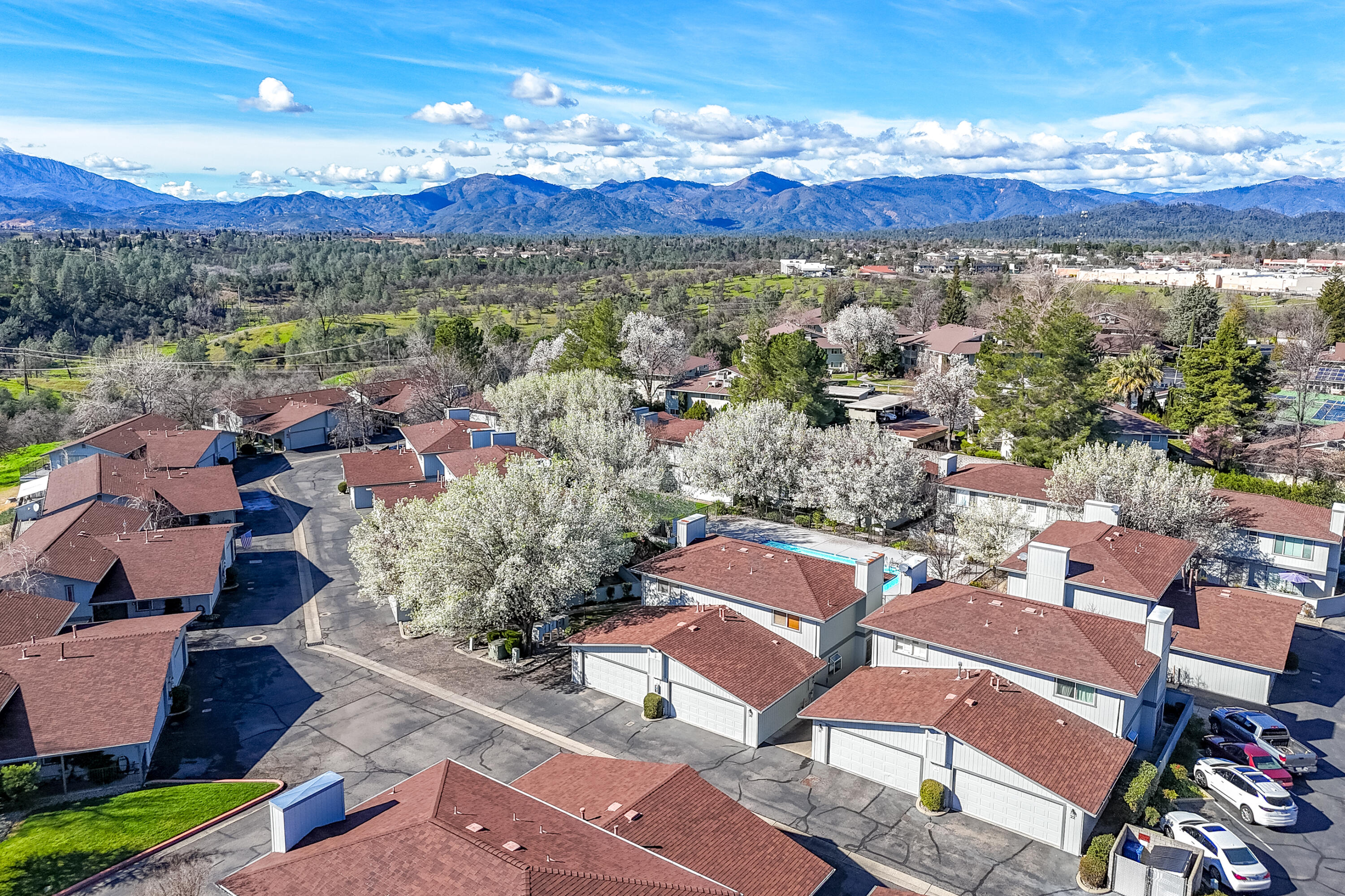 200 Ridgetop Drive, Unit 19 Redding, CA 96003 - Photo 47 of 53 an aerial view of a city with lots of residential buildings and mountain view in back