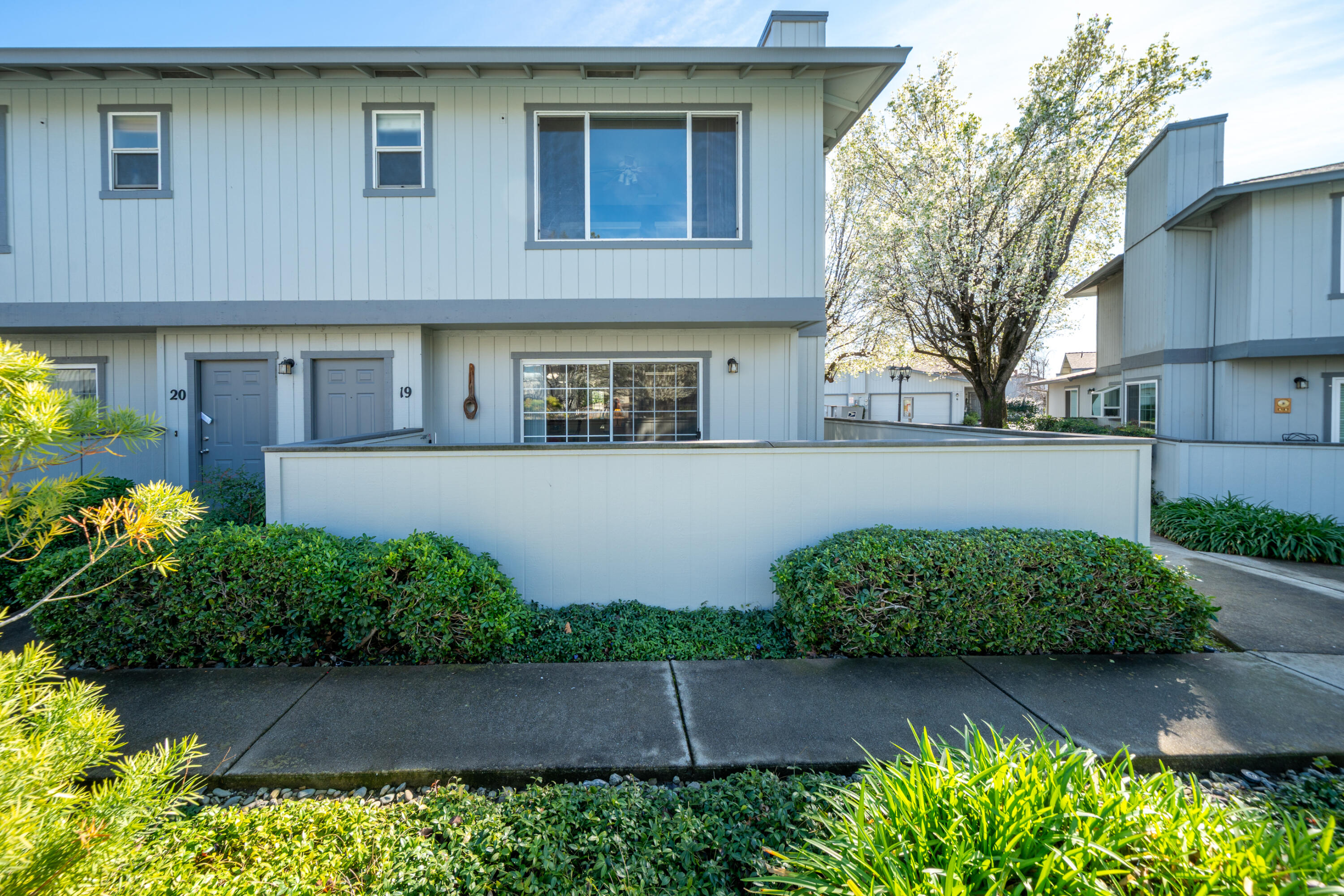 200 Ridgetop Drive, Unit 19 Redding, CA 96003 - Photo 7 of 53 a front view of a house with a yard and outdoor seating