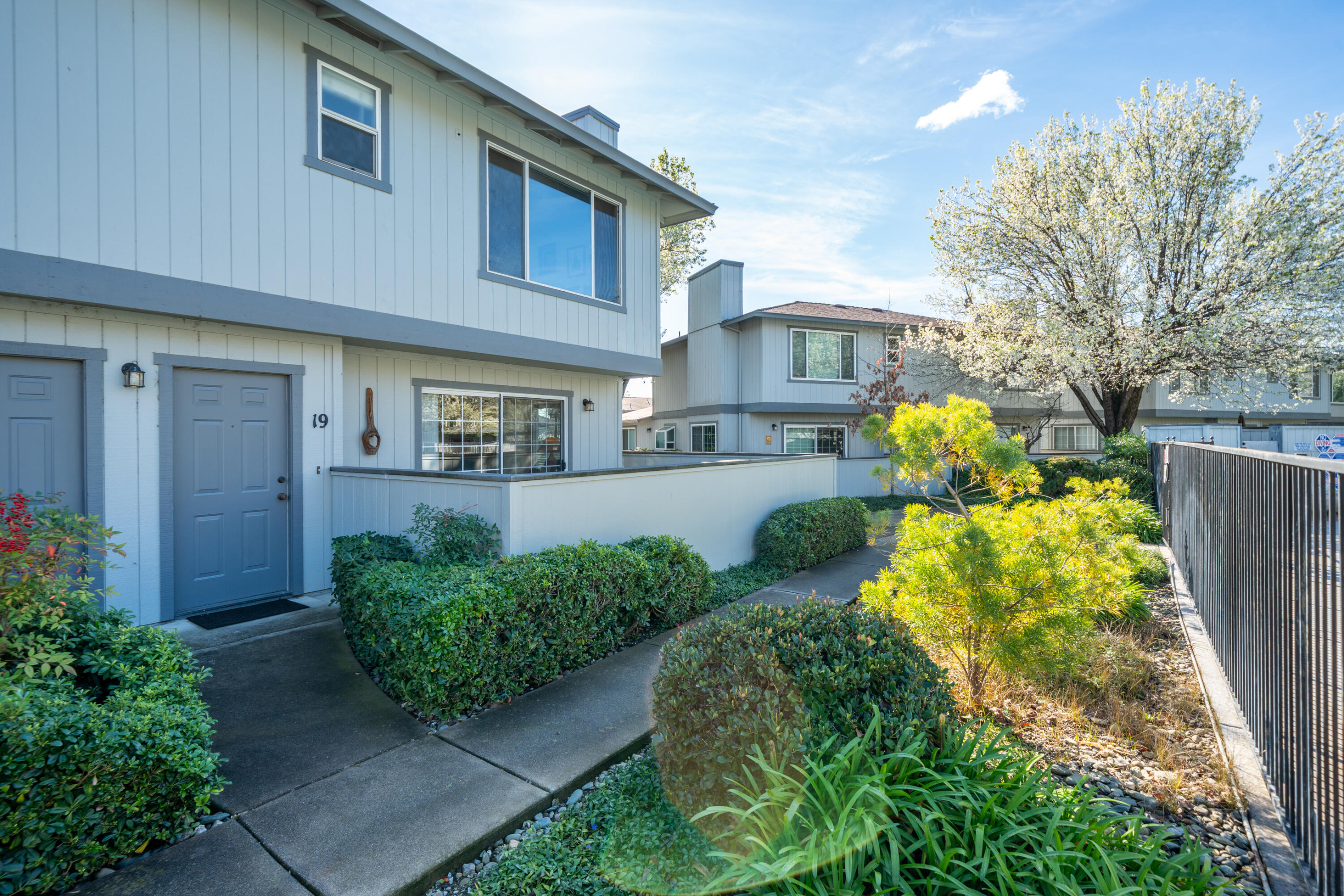 200 Ridgetop Drive, Unit 19 Redding, CA 96003 - Photo 8 of 53 a front view of a house with a yard and outdoor seating