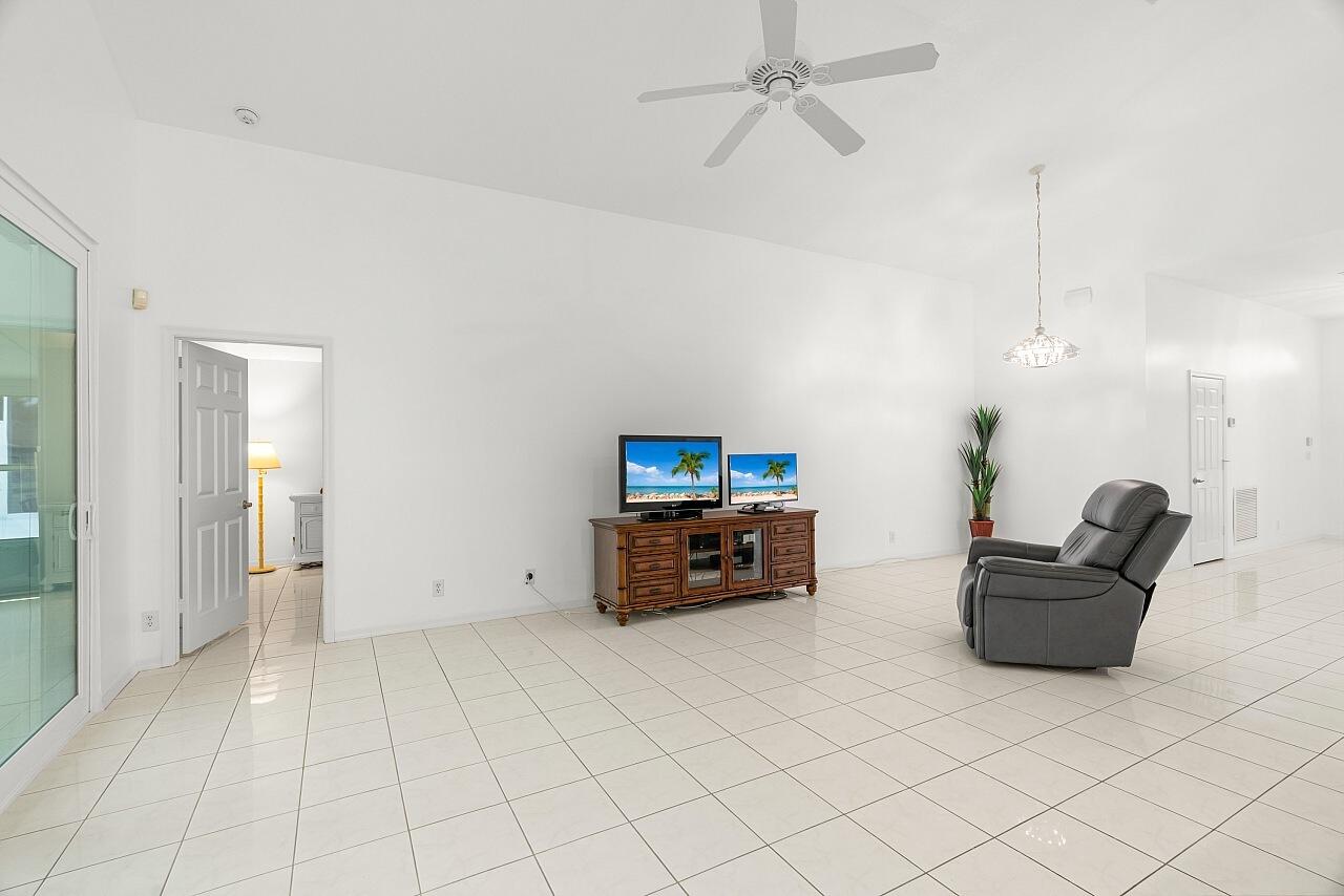 7313 Southeast Seagate Lane Stuart, FL 34997 - Photo 16 of 50 a living room with furniture and a flat screen tv