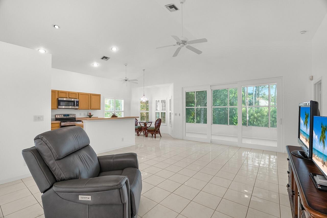 7313 Southeast Seagate Lane Stuart, FL 34997 - Photo 17 of 50 a living room with furniture and a flat screen tv