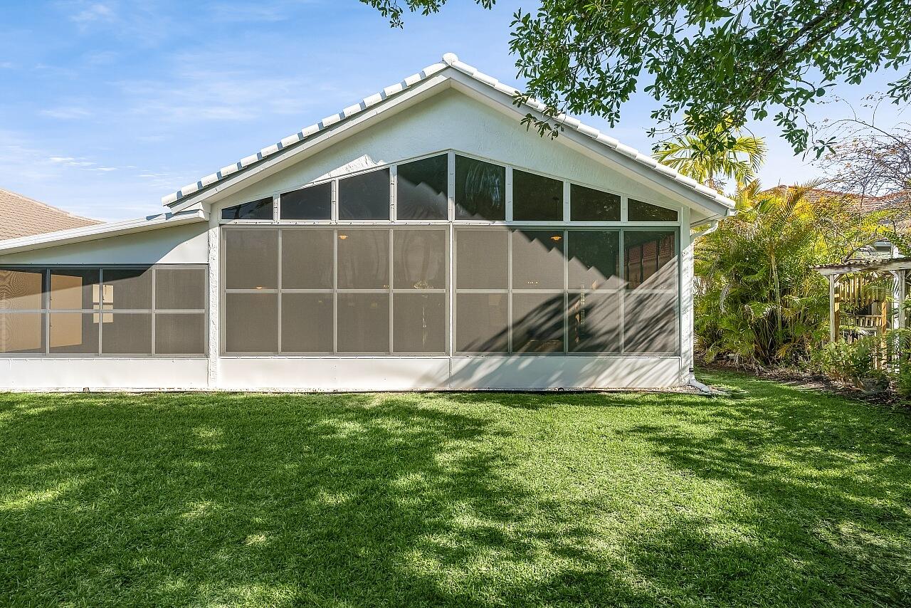 7313 Southeast Seagate Lane Stuart, FL 34997 - Photo 36 of 50 a view of a house with a yard and sitting area