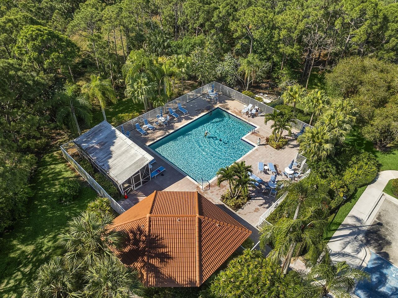 7313 Southeast Seagate Lane Stuart, FL 34997 - Photo 45 of 50 an aerial view of a house with a yard and large trees