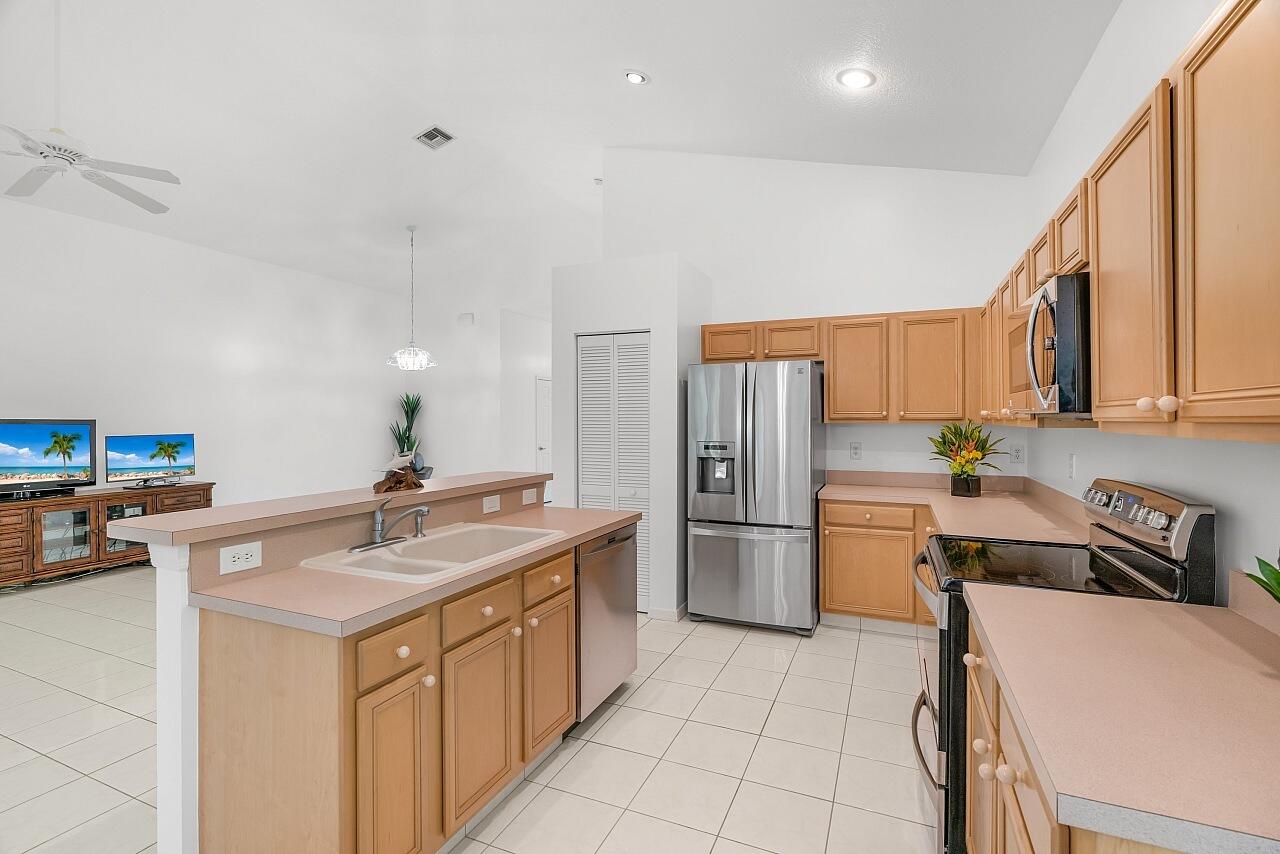 7313 Southeast Seagate Lane Stuart, FL 34997 - Photo 7 of 50 a kitchen with a sink appliances and cabinets