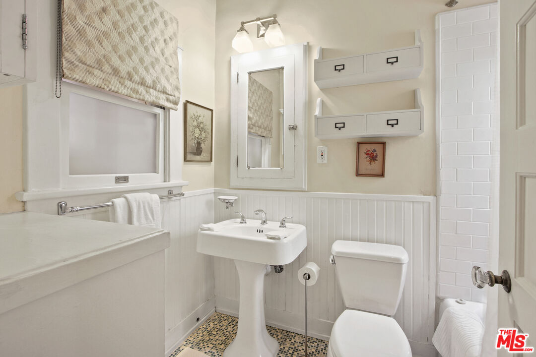 617 North Plymouth Boulevard, Unit 617 1/2 Los Angeles, CA 90004 - Photo 11 of 20 a bathroom with a sink toilet and mirror