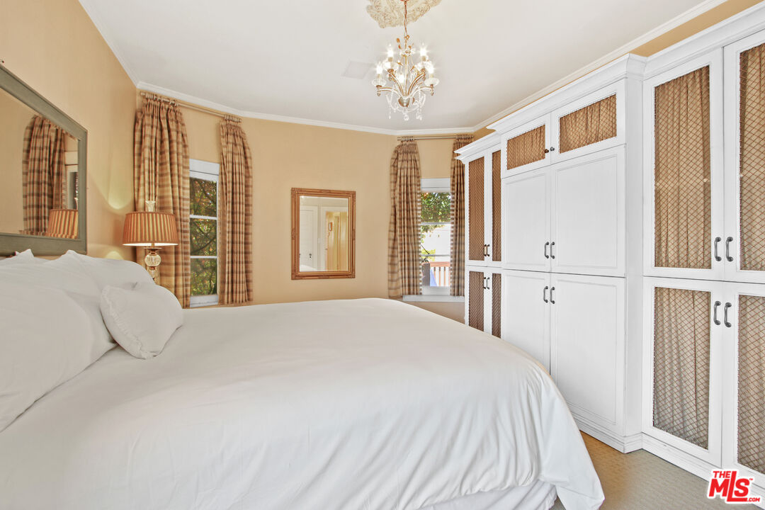 617 North Plymouth Boulevard, Unit 617 1/2 Los Angeles, CA 90004 - Photo 14 of 20 a bedroom with a large bed and wooden floor