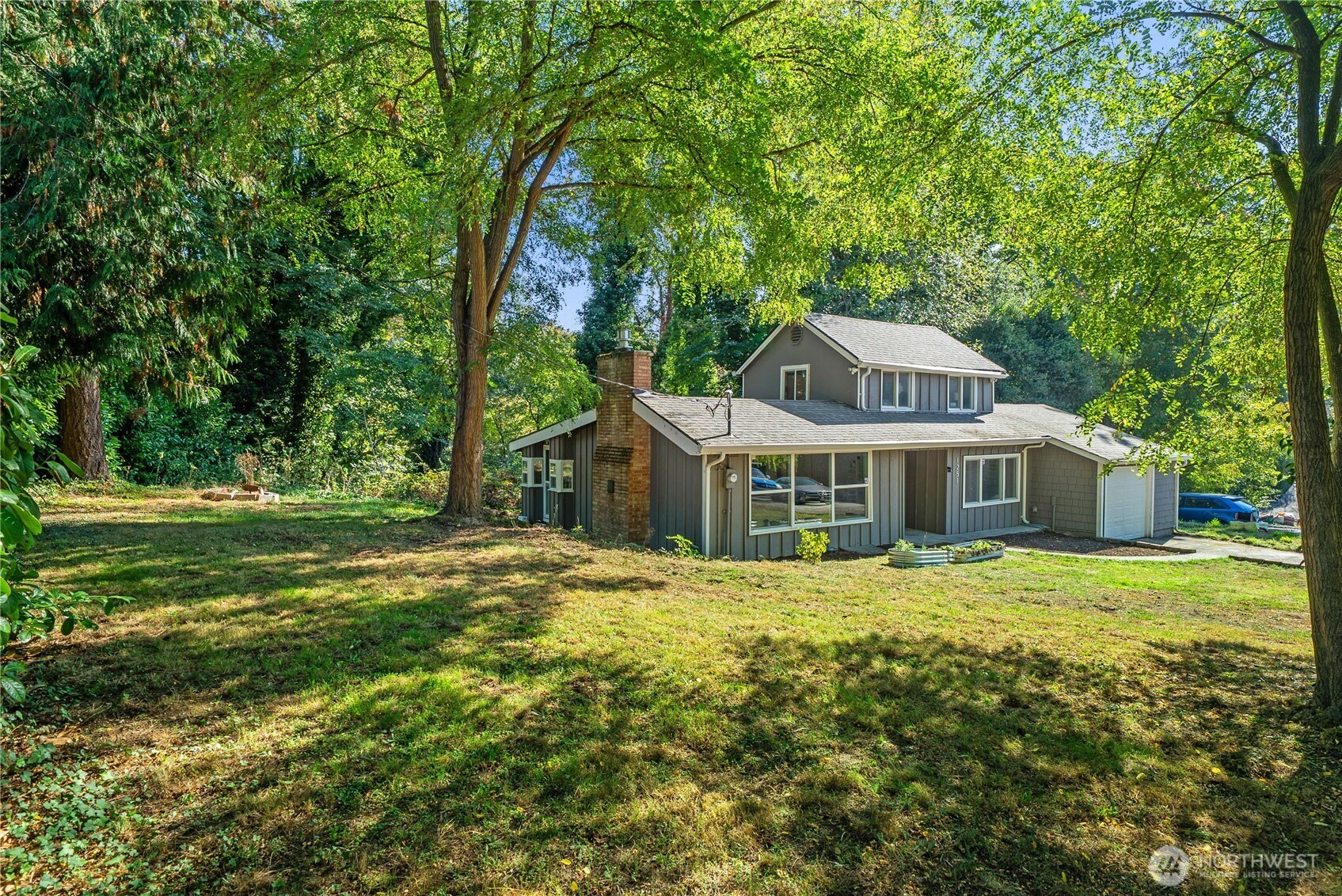 1251 South 230th Street Des Moines, WA 98198 - Photo 22 of 27 a front view of a house with a garden