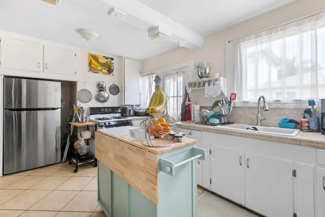 a very nice looking kitchen with granite countertop a sink stainless steel appliances and cabinets