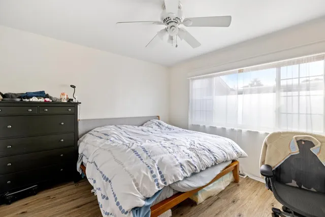 a backyard of a house with table and chairs wooden fence