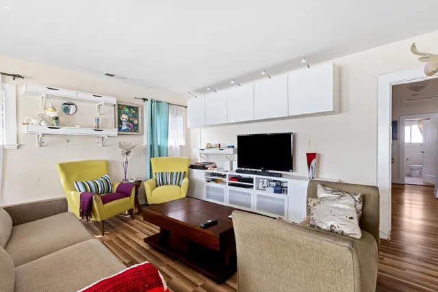 a living room with furniture fireplace and a large window