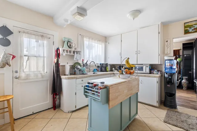 a kitchen with a sink appliances and cabinets