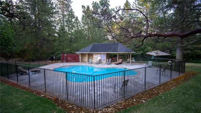 an outdoor space with pool and furniture