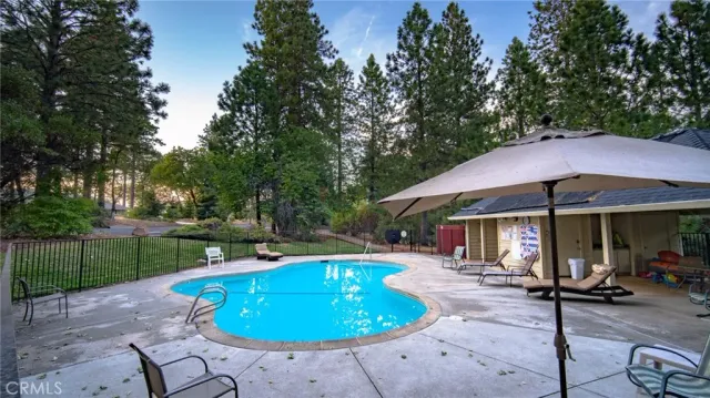a view of a fire pit with tall trees