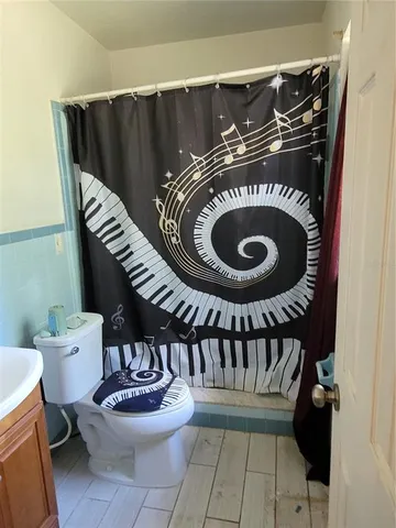 a view of a house with a yard chairs and a tree