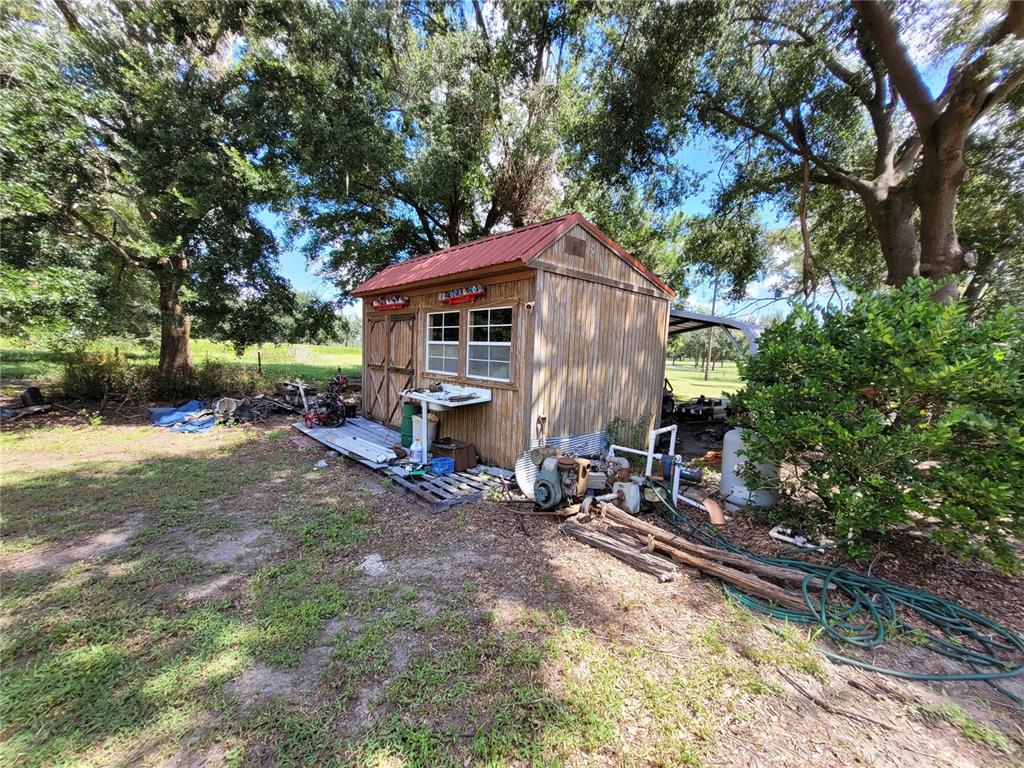 801 9th Street Northeast Fort Meade, FL 33841 - Photo 12 of 14 a view of a house with a yard chairs and a tree