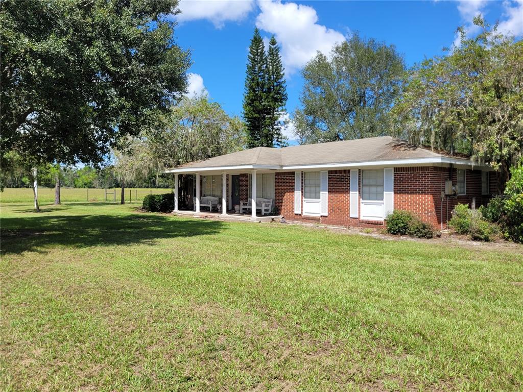 801 9th Street Northeast Fort Meade, FL 33841 - Photo 2 of 14 a view of a house with a yard table and chairs