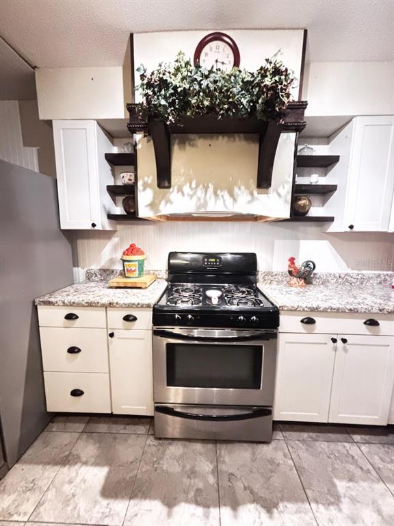 801 9th Street Northeast Fort Meade, FL 33841 - Photo 4 of 14 a kitchen with stainless steel appliances granite countertop a stove and a sink