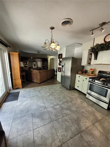 a view of a hallway with wooden floor and a potted plant