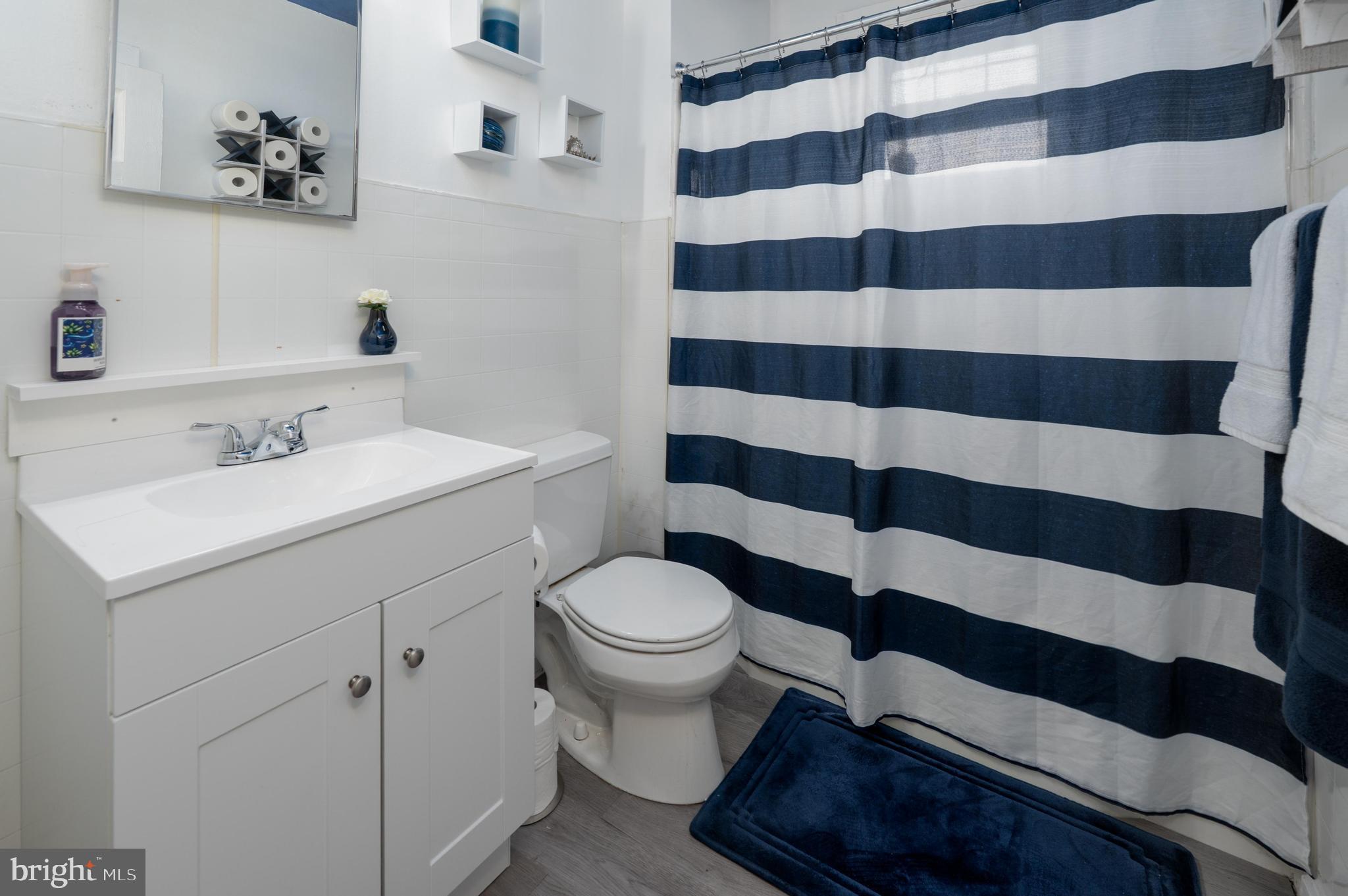 261 South Fellowship Road Maple Shade, NJ 08052 - Photo 15 of 30 a bathroom with a sink a toilet a shower and a mirror
