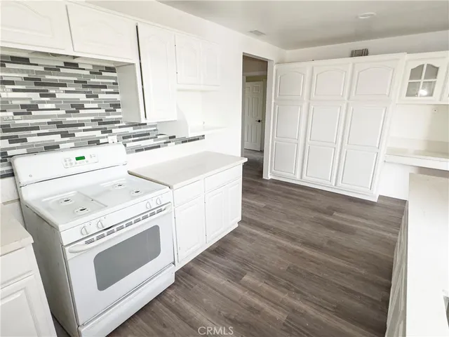 a kitchen with a stove a sink and a microwave
