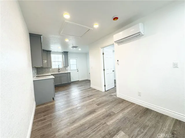 a view of kitchen with wooden floor and electronic appliances