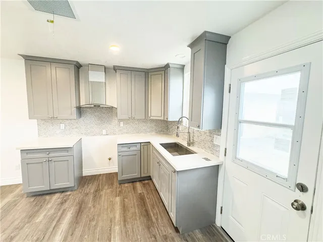 a kitchen with a sink stove and cabinets