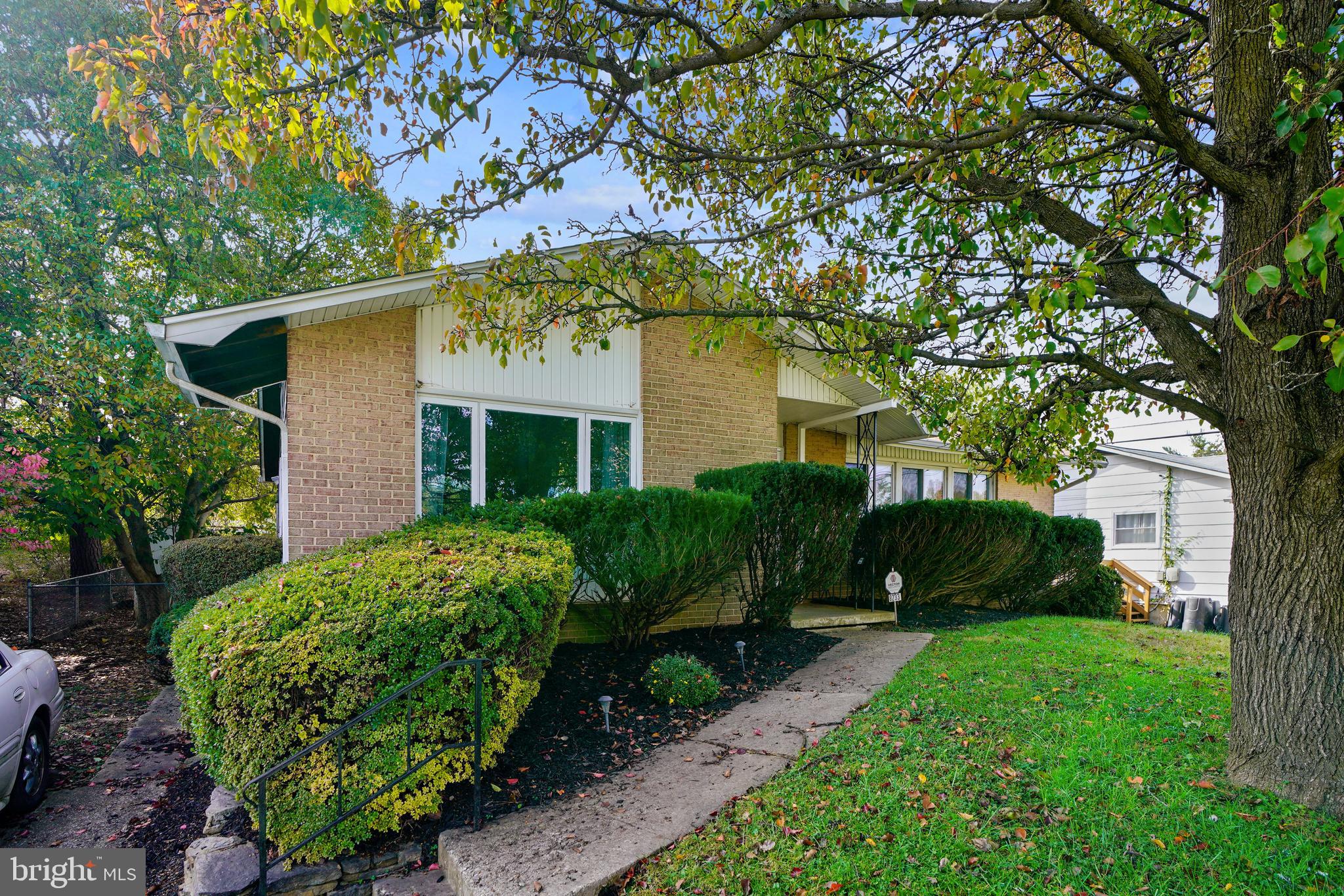 8233 Scotts Level Road Baltimore, MD 21208 - Photo 2 of 37 a front view of a house with garden
