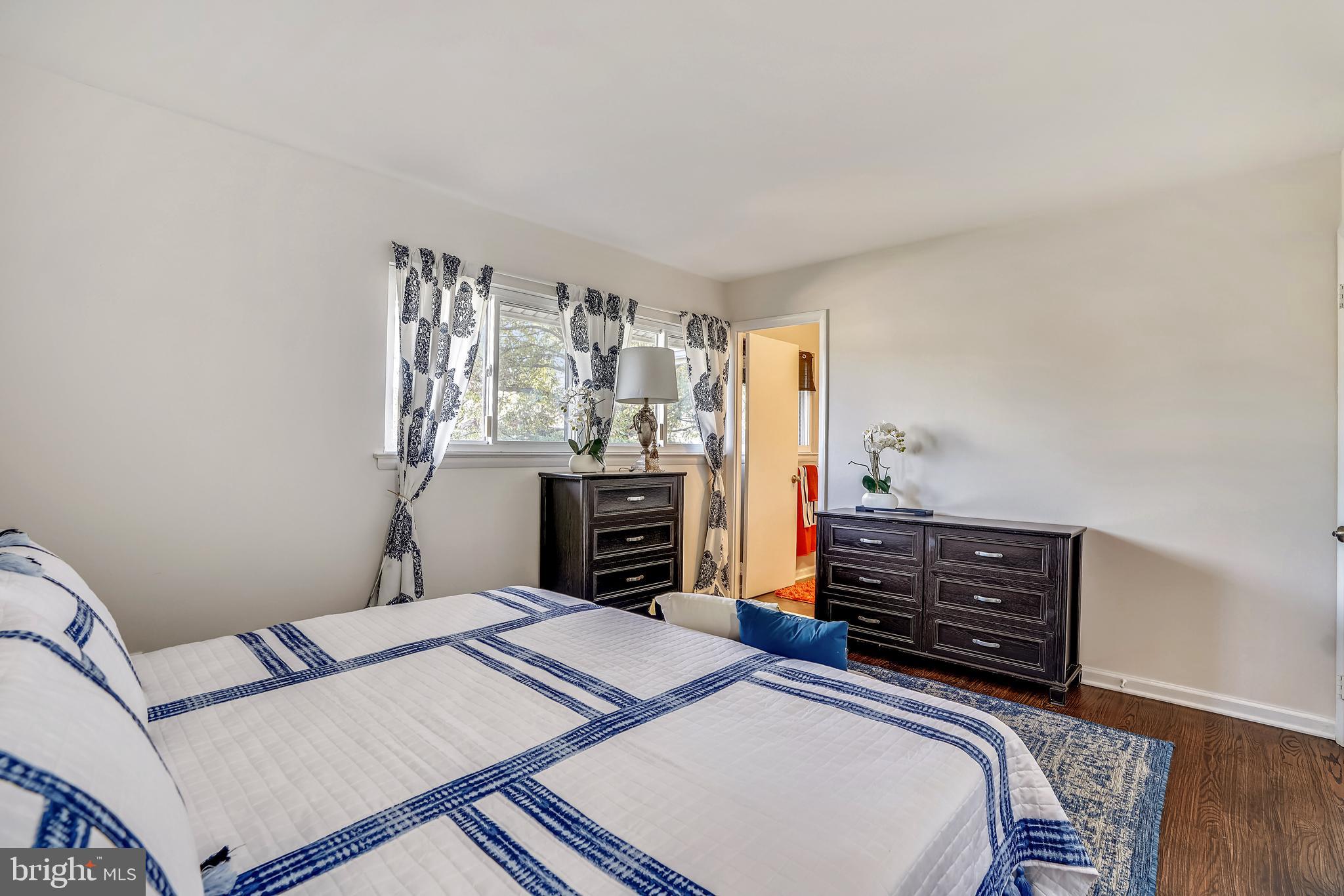 8233 Scotts Level Road Baltimore, MD 21208 - Photo 20 of 37 a bedroom with a bed and a fireplace