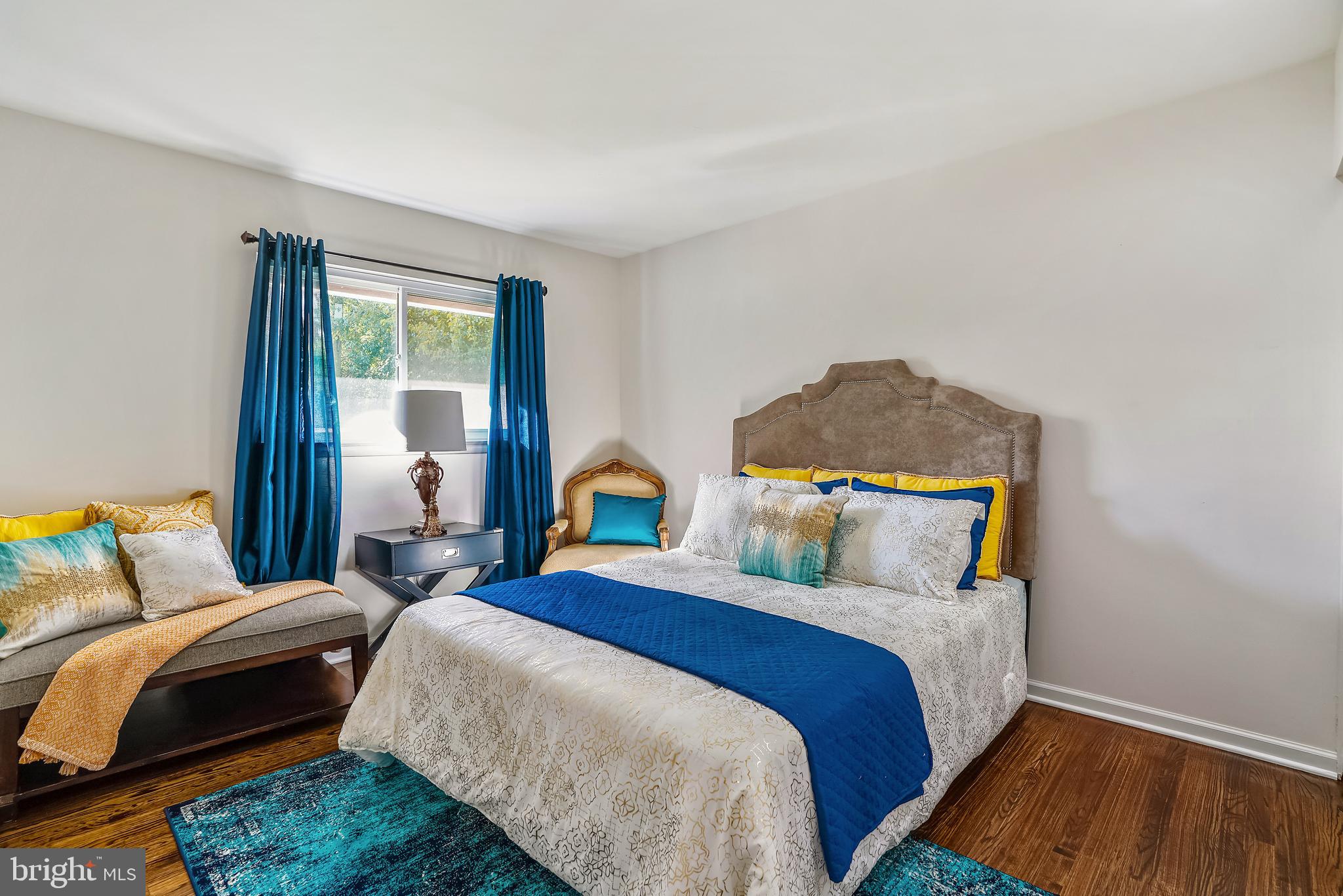 8233 Scotts Level Road Baltimore, MD 21208 - Photo 21 of 37 a bedroom with a bed and wooden floor