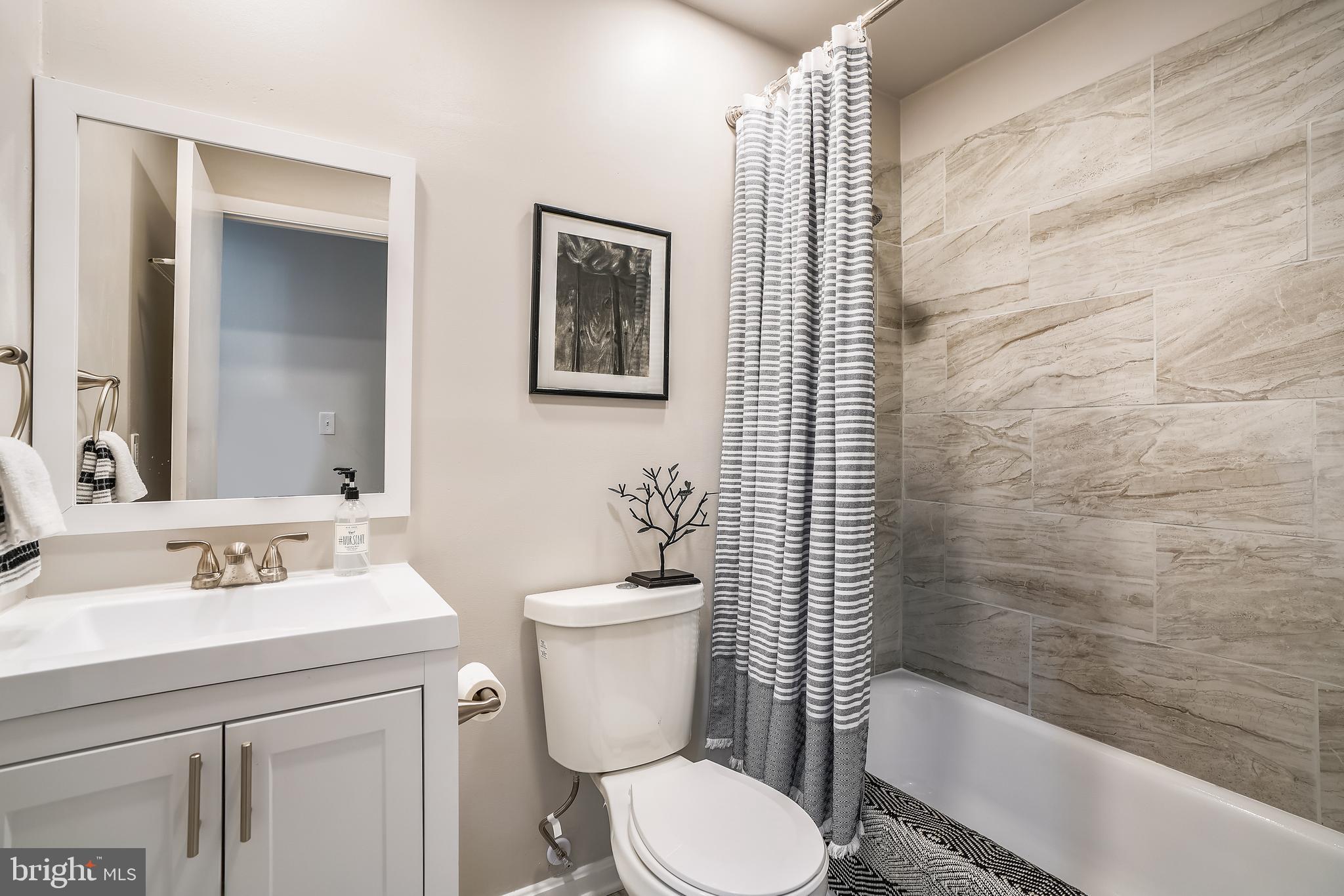 8233 Scotts Level Road Baltimore, MD 21208 - Photo 23 of 37 a bathroom with a sink toilet and shower