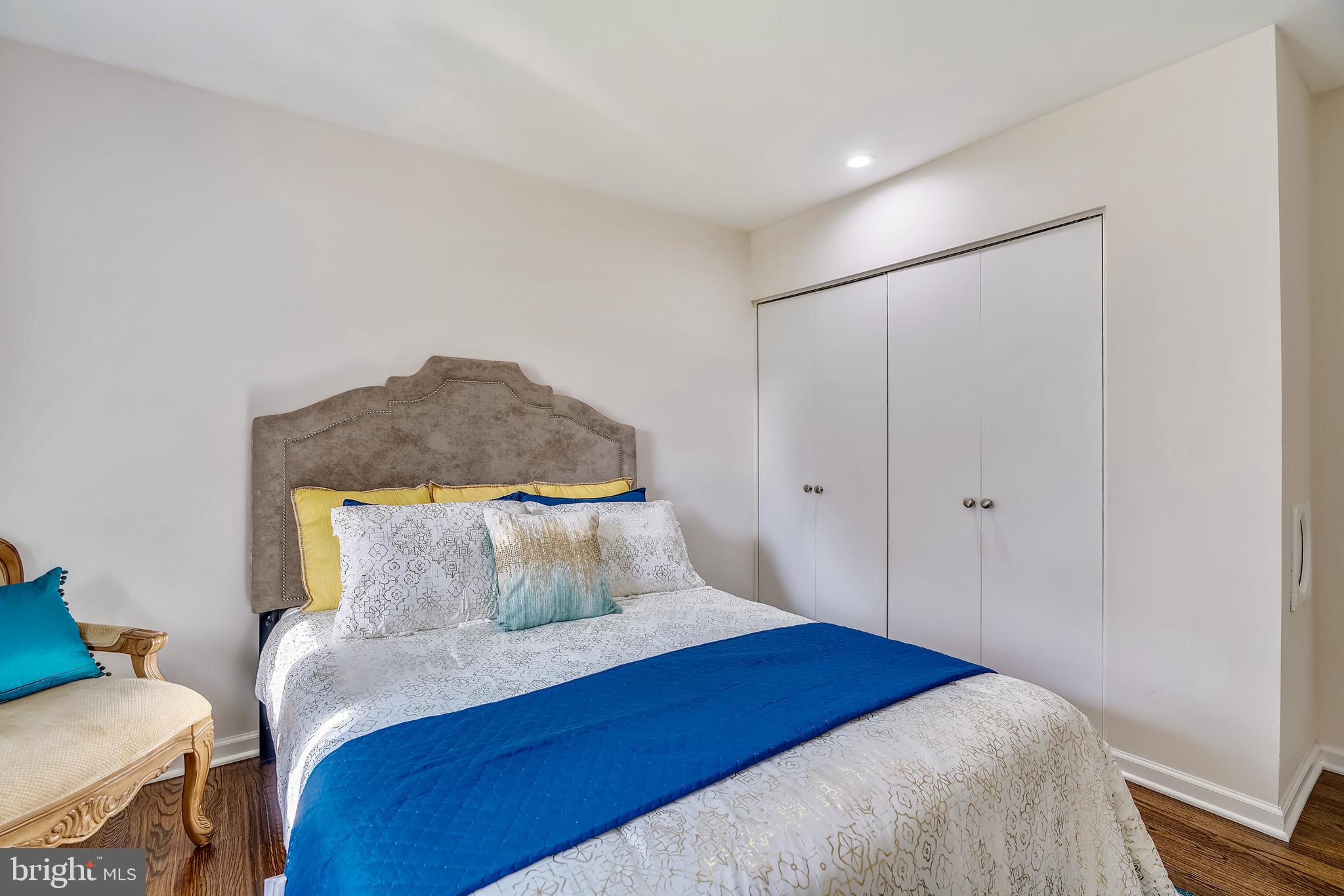 8233 Scotts Level Road Baltimore, MD 21208 - Photo 24 of 37 a bedroom with a bed and a painting on the wall