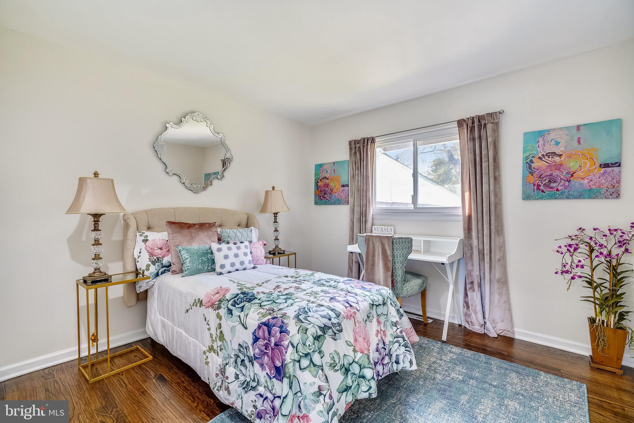 8233 Scotts Level Road Baltimore, MD 21208 - Photo 25 of 37 a bedroom with a bed and wooden floor