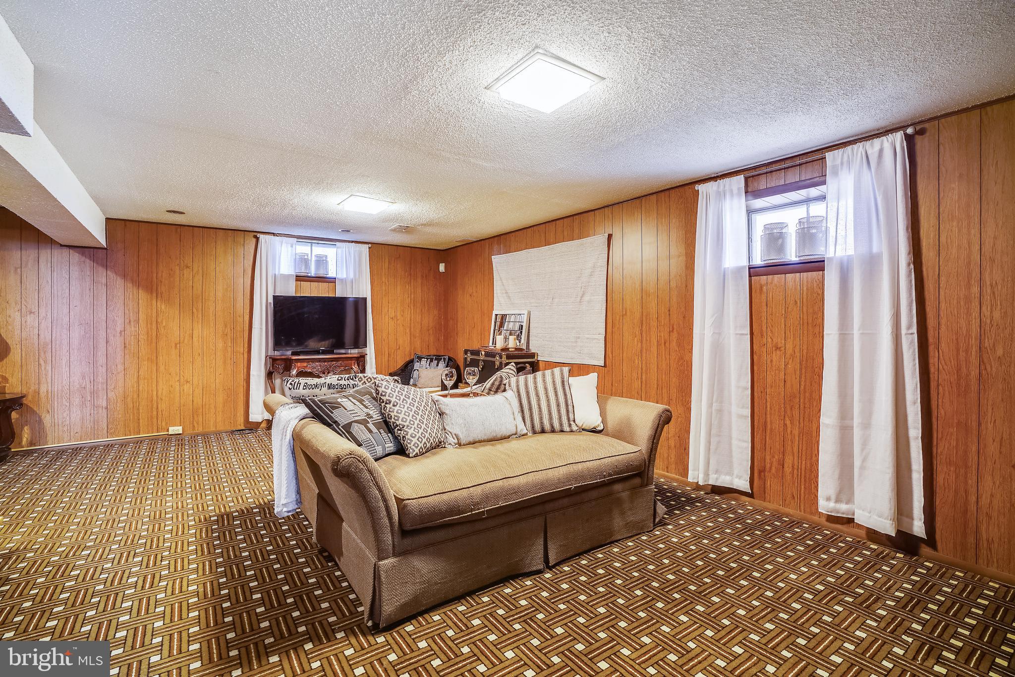 8233 Scotts Level Road Baltimore, MD 21208 - Photo 29 of 37 a living room with furniture and a flat screen tv