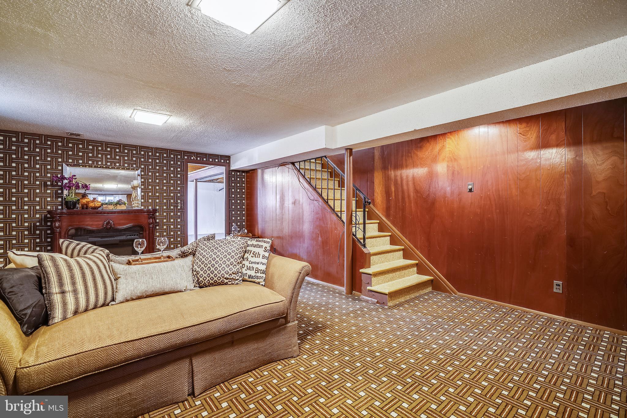 8233 Scotts Level Road Baltimore, MD 21208 - Photo 31 of 37 a living room with furniture and stairs
