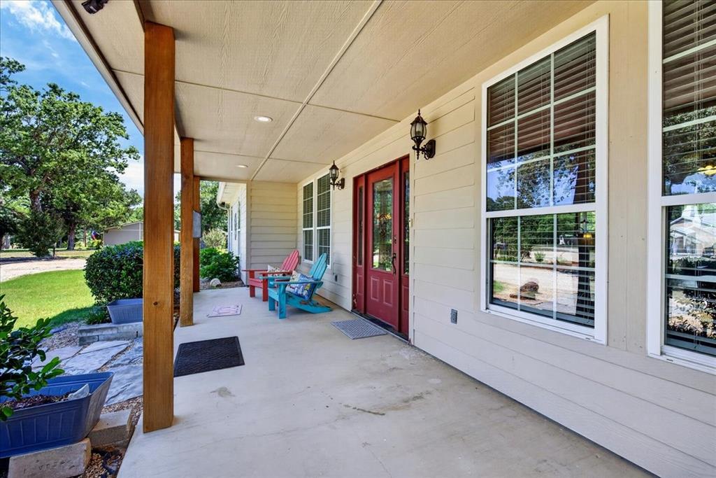 11591 Farm To Market 59 Athens, TX 75751 - Photo 4 of 40 Expansive front porch featuring exposed wood support beams and a concrete surface. Sit down awhile and enjoy country life on the front porch.