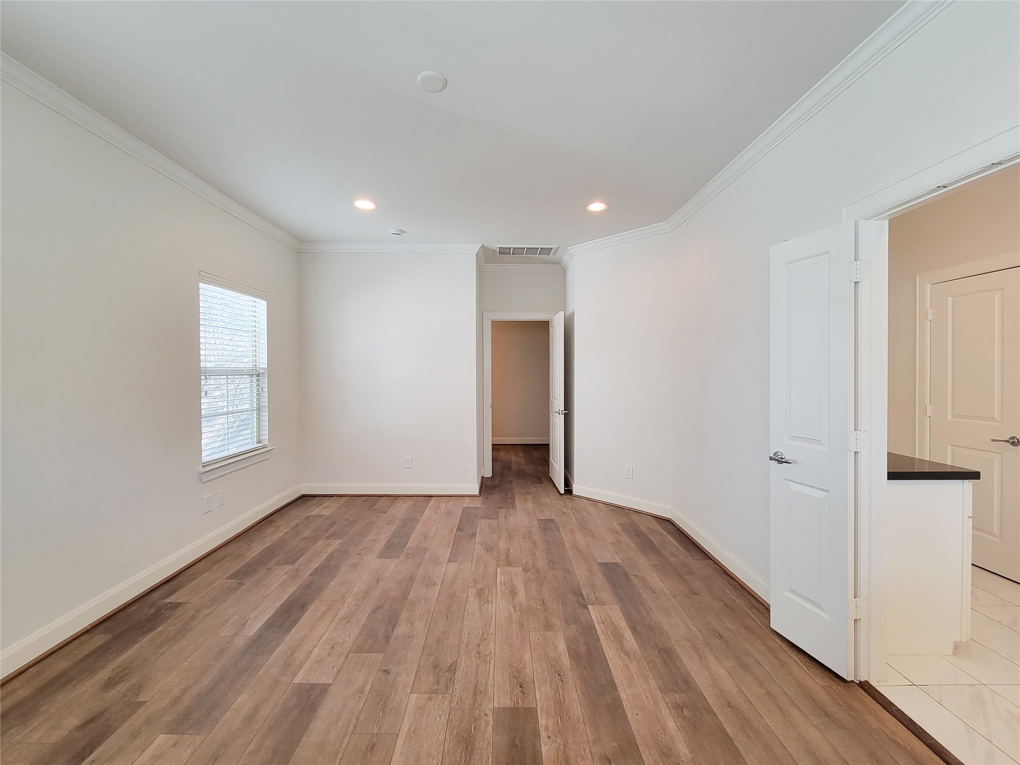 12 Hermann Park Court Houston, TX 77021 - Photo 27 of 43 a view of an empty room with wooden floor and a window