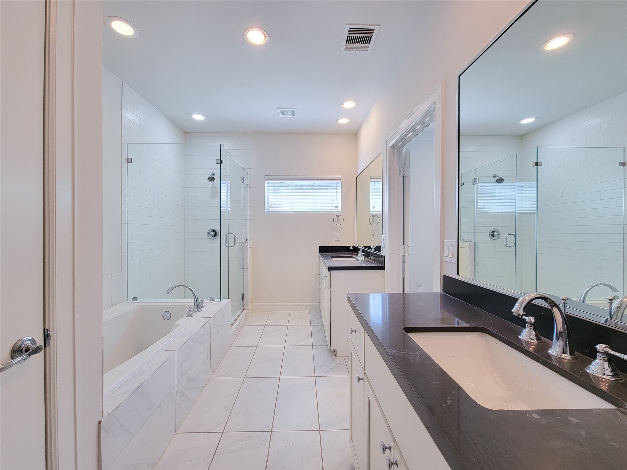 12 Hermann Park Court Houston, TX 77021 - Photo 32 of 43 a bathroom with a granite countertop sink a large mirror and shower