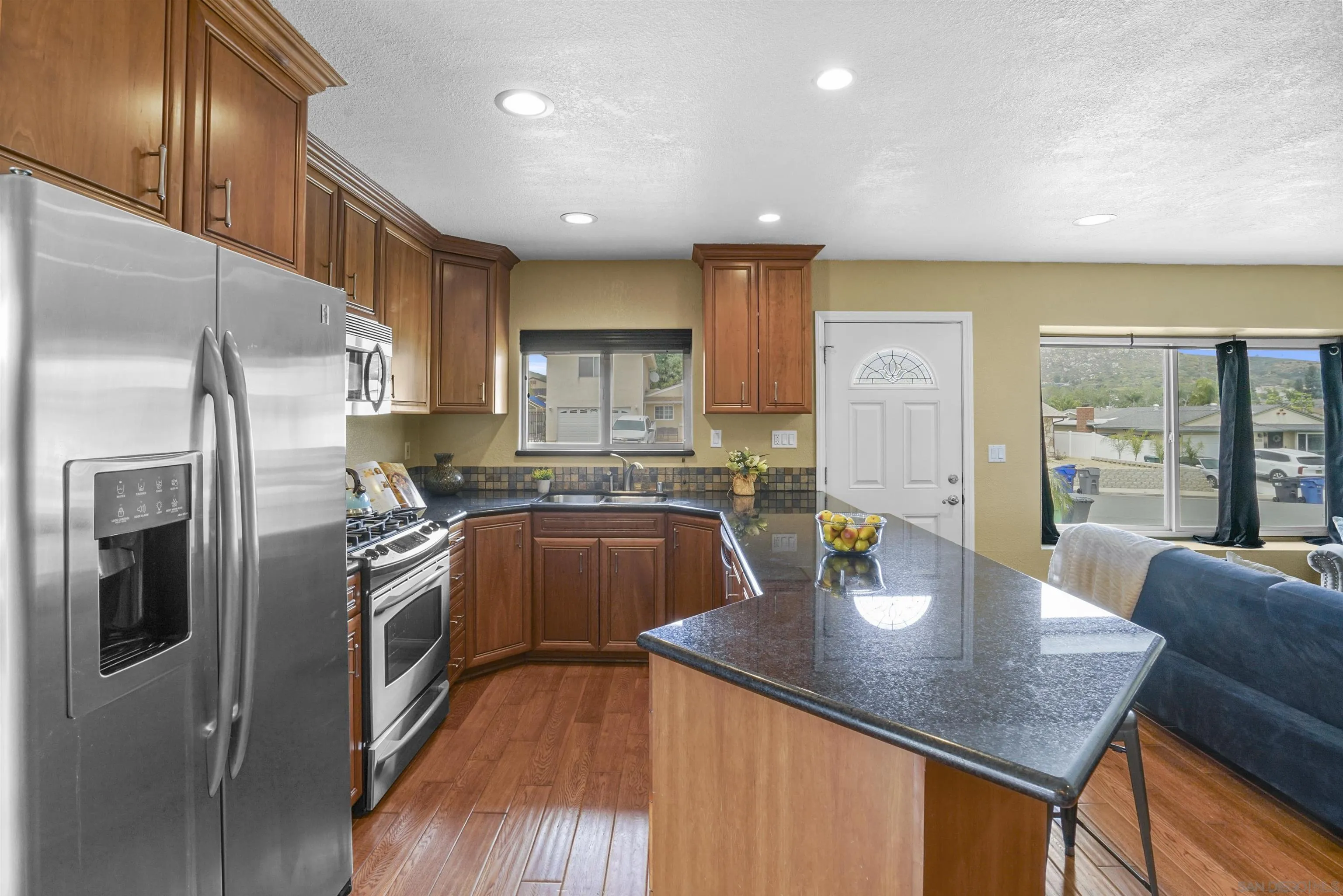 10111 White Pine Lane Santee, CA 92071 - Photo 11 of 35 a kitchen with stainless steel appliances granite countertop a sink a stove and a refrigerator