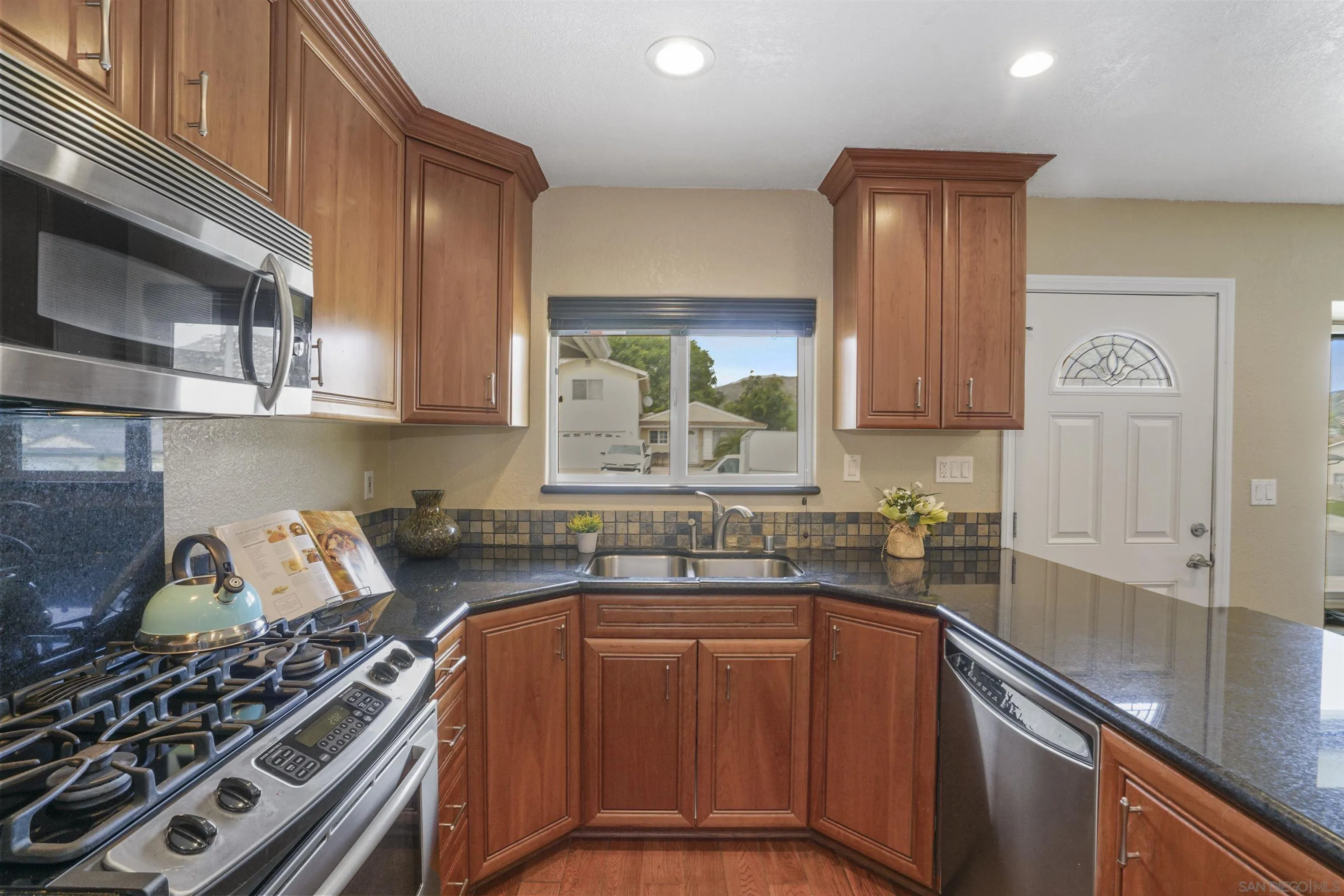 10111 White Pine Lane Santee, CA 92071 - Photo 14 of 35 a kitchen with a sink a stove and cabinets