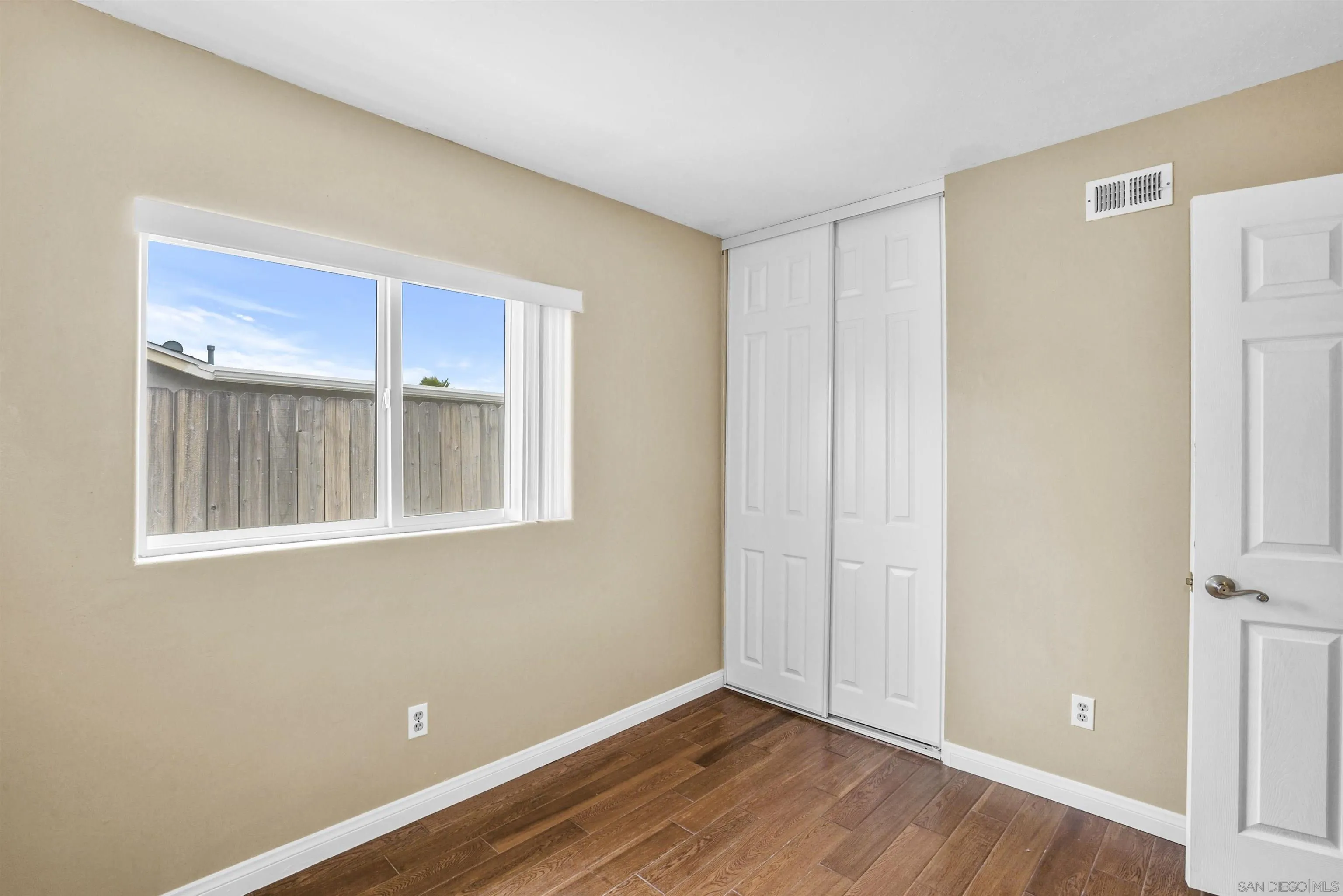 10111 White Pine Lane Santee, CA 92071 - Photo 22 of 35 a view of an empty room with wooden floor and a window