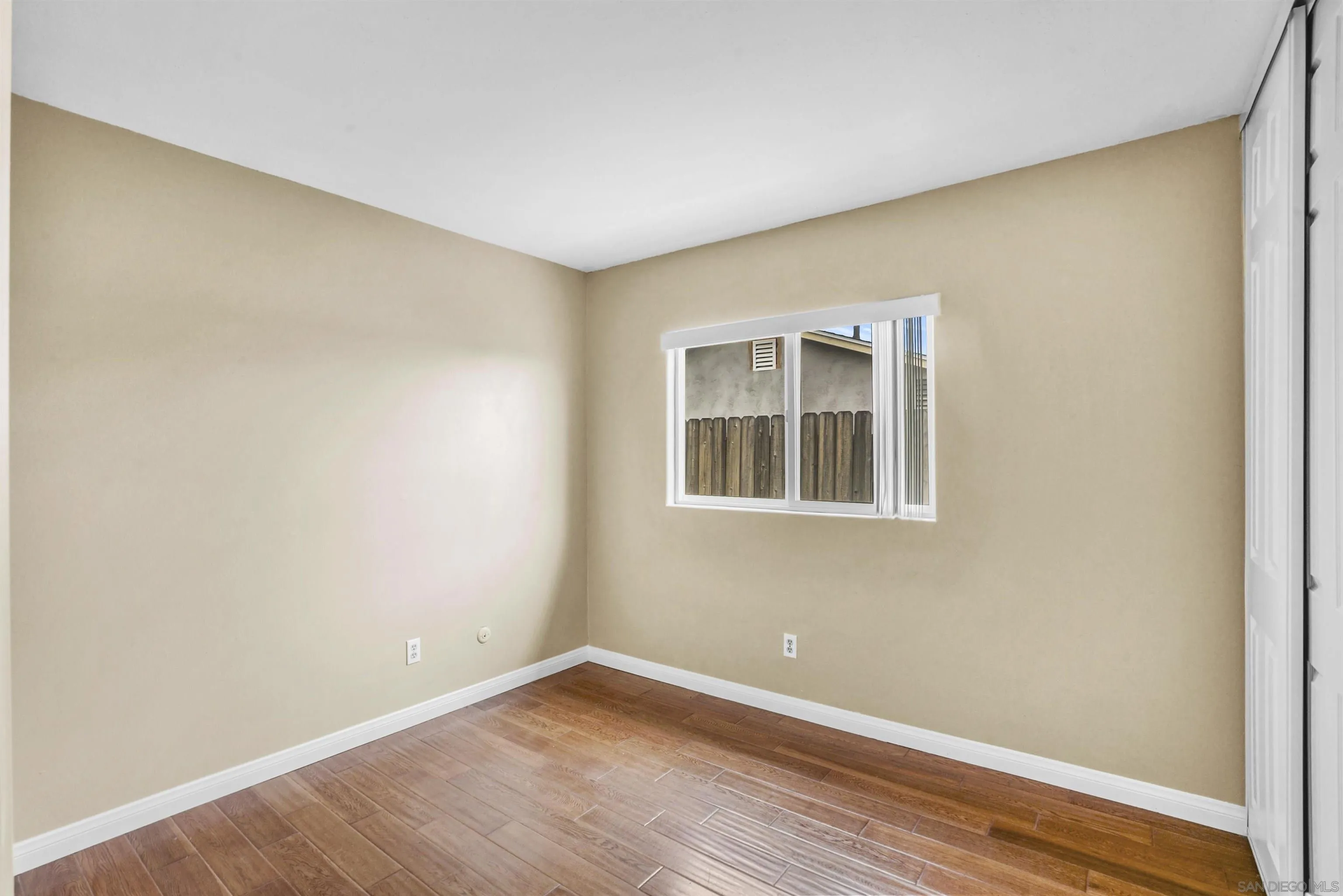 10111 White Pine Lane Santee, CA 92071 - Photo 23 of 35 a view of an empty room with wooden floor and a window