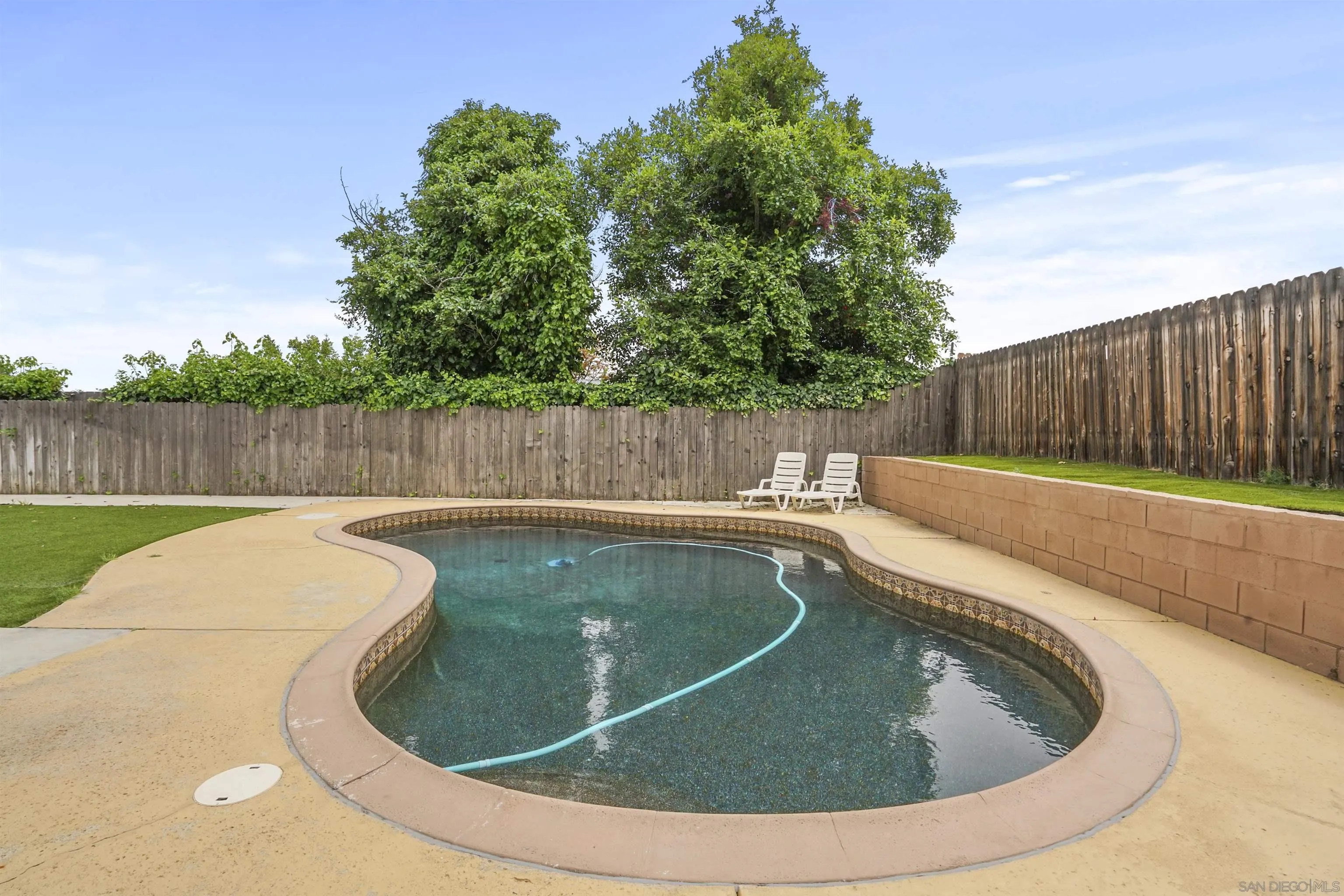 10111 White Pine Lane Santee, CA 92071 - Photo 26 of 35 a view of a swimming pool with a couches and wooden fence