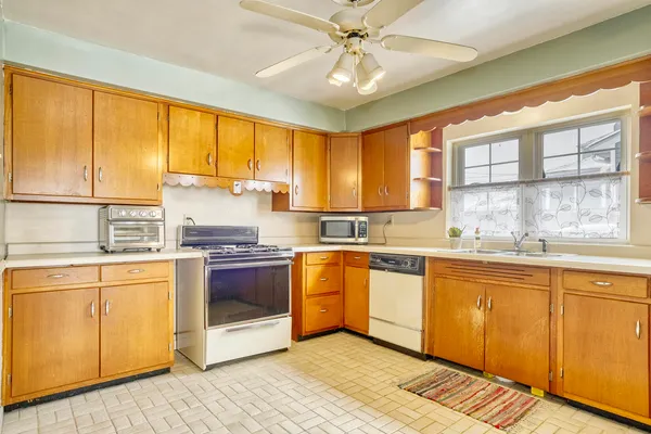 a kitchen with stainless steel appliances granite countertop a stove and cabinets