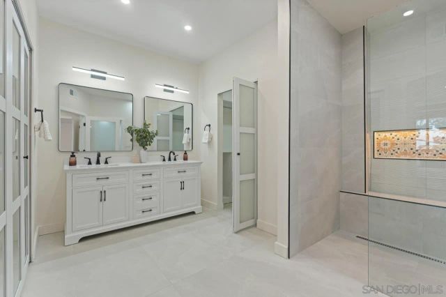 a bathroom with a double vanity sink and mirror
