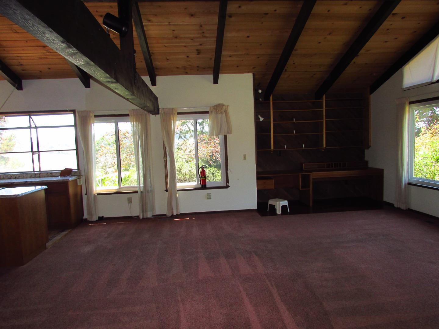 3355 Conant Lane Watsonville, CA 95076 - Photo 11 of 52 a view of an empty room with a fireplace and a window