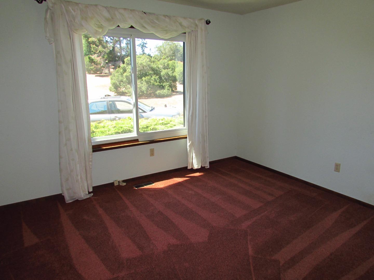 3355 Conant Lane Watsonville, CA 95076 - Photo 24 of 52 an empty room with wooden floor and windows