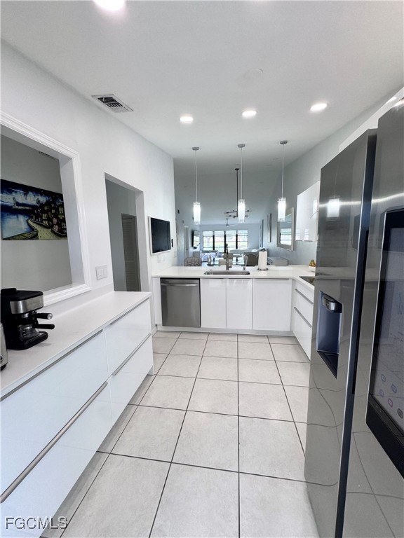 4079 Northlight Drive, Unit 1802 Naples, FL 34112 - Photo 11 of 29 a kitchen with stainless steel appliances a sink a stove a refrigerator and cabinets