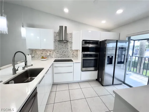 a kitchen with stainless steel appliances a refrigerator sink and cabinets