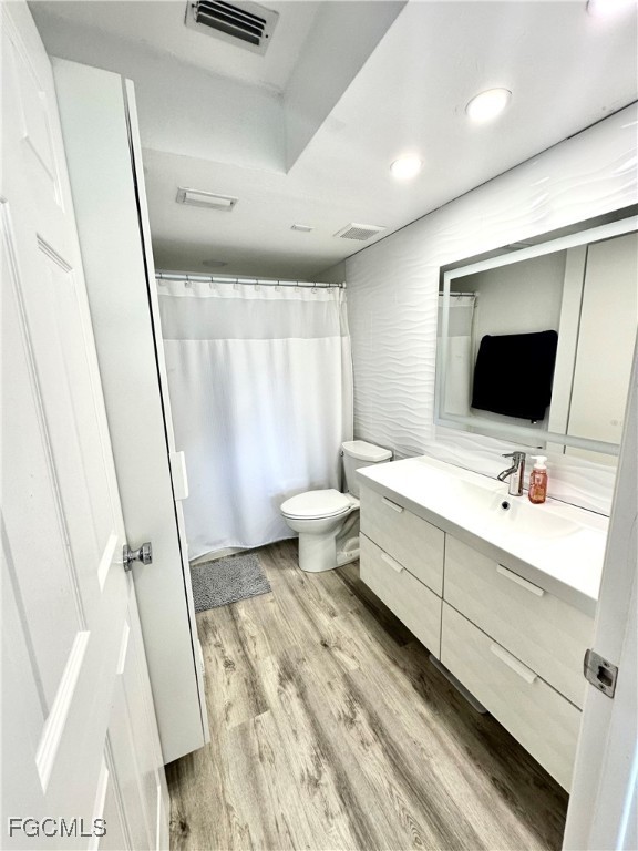 4079 Northlight Drive, Unit 1802 Naples, FL 34112 - Photo 16 of 29 a bathroom with a sink a toilet and mirror
