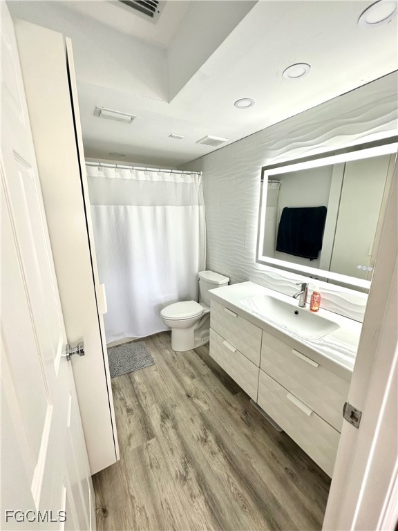 4079 Northlight Drive, Unit 1802 Naples, FL 34112 - Photo 17 of 29 a bathroom with a sink a mirror and a toilet